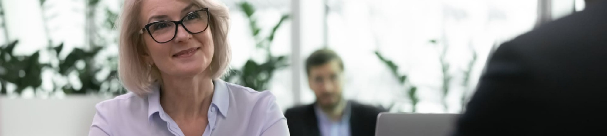 Smiling businesswoman leading interview with a candidate listening to their response