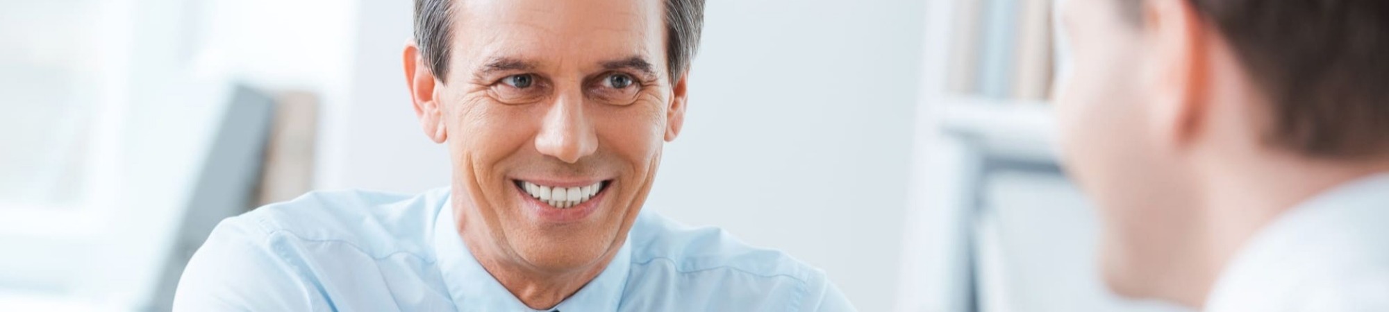 Interviewer smiling at applicant during an interview set in an office