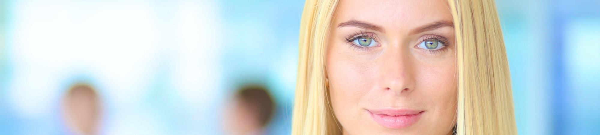 Businesswoman in office with colleagues in the background